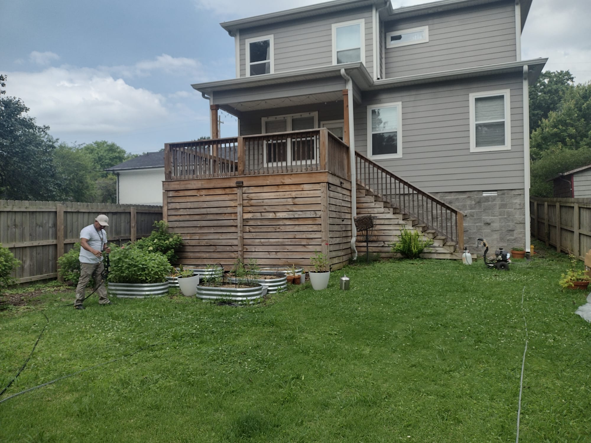 Exterior painting — gray two-story house with freshly stained deck in Nashville